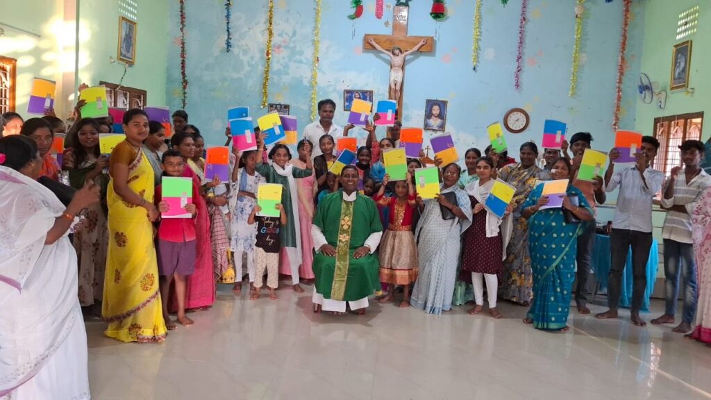 distribution of notebooks and pens at endroy in amaravathi parish